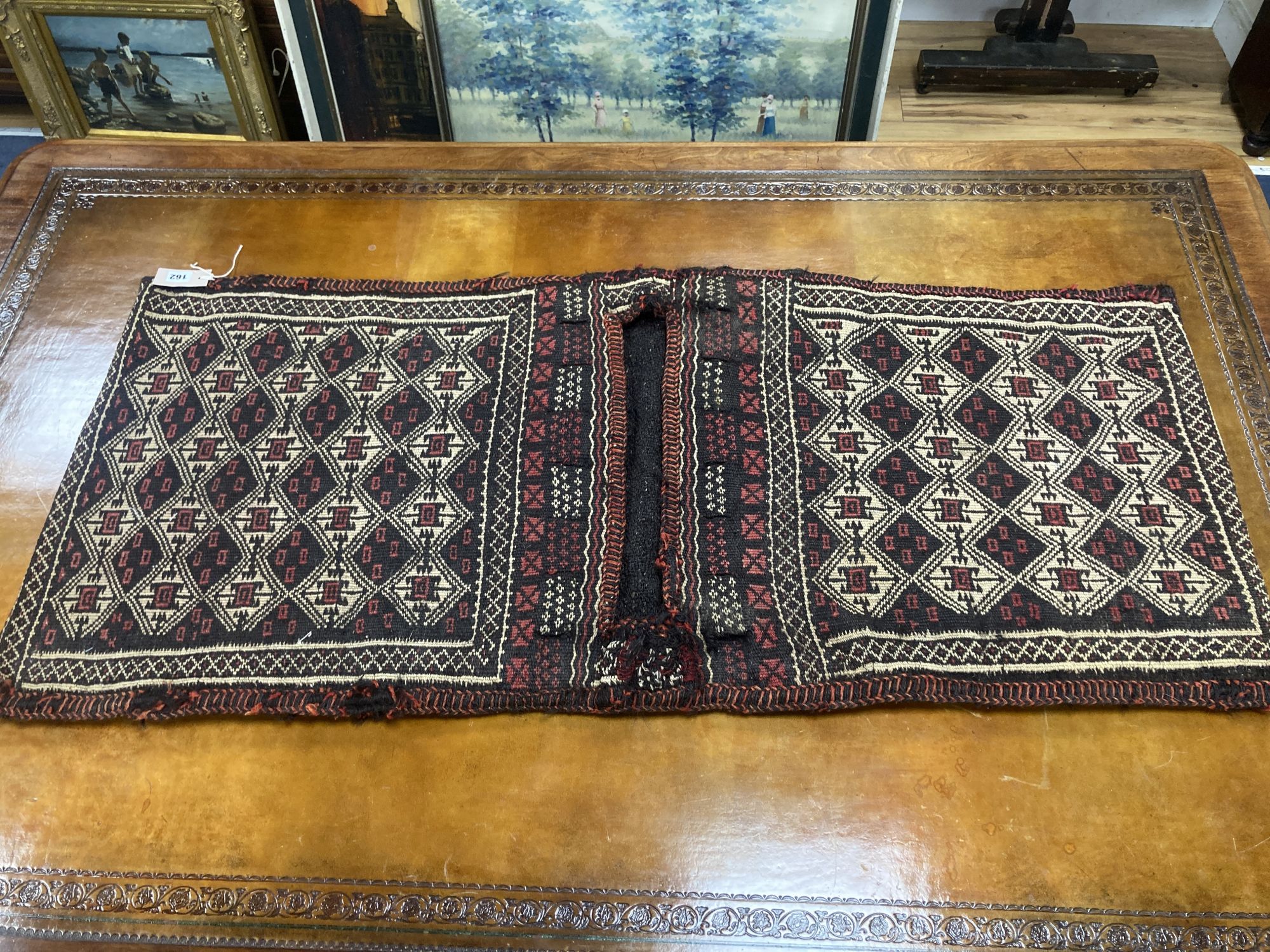 Six Caucasian design mats and a saddlebag, largest 140 x 60cm